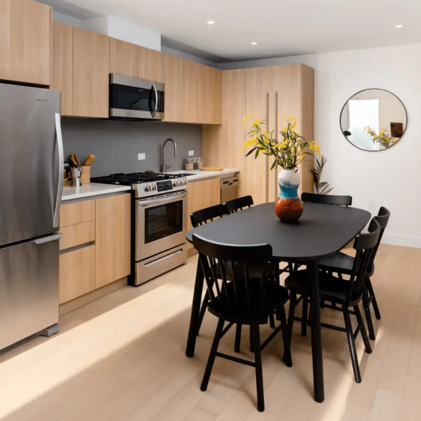 Contractor and homeowner reviewing renovation plans and material samples on a modern kitchen counter