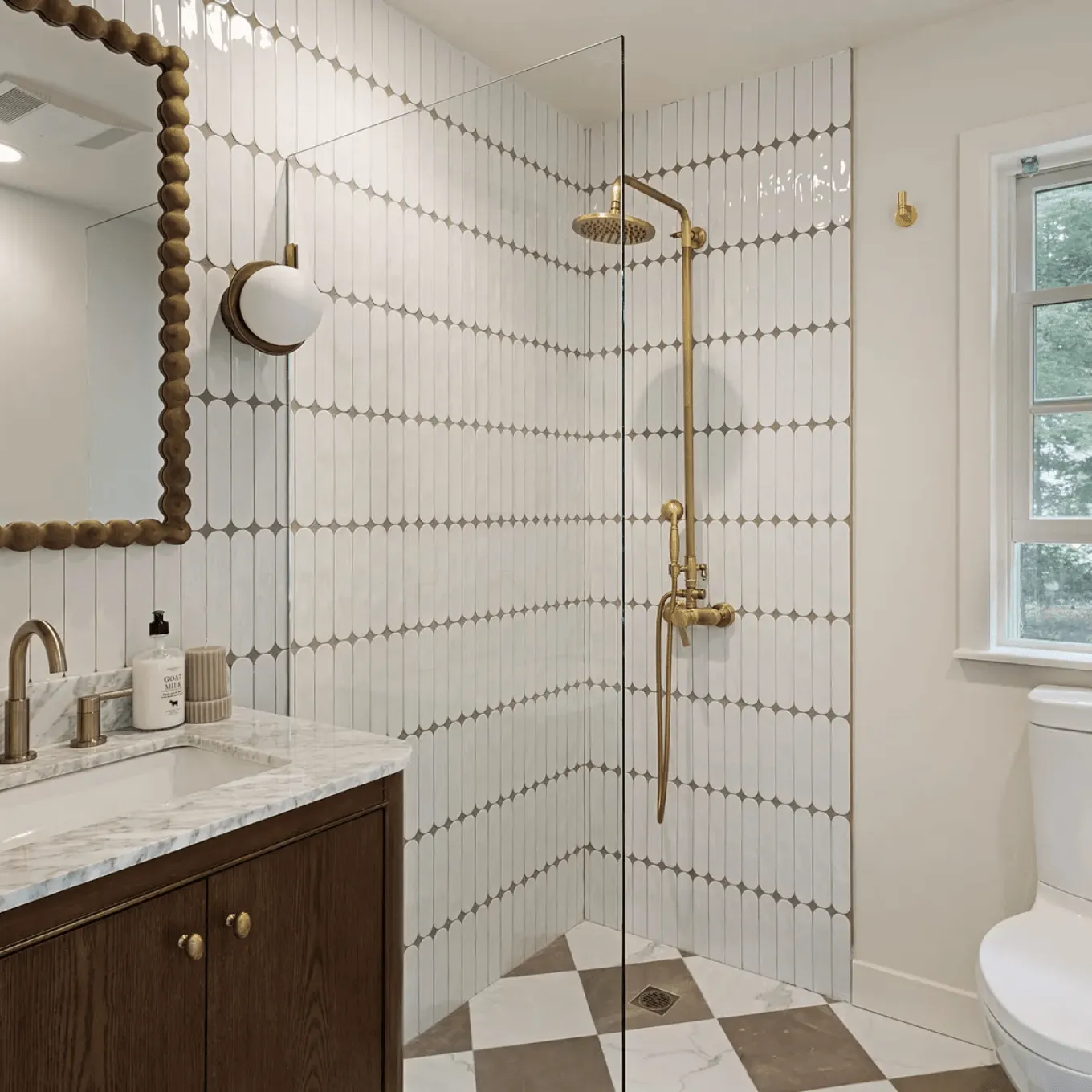 Bathroom renovation with white subway tile walls, gray vanity, black faucet, and gray tile floor in Westchester, NY.
