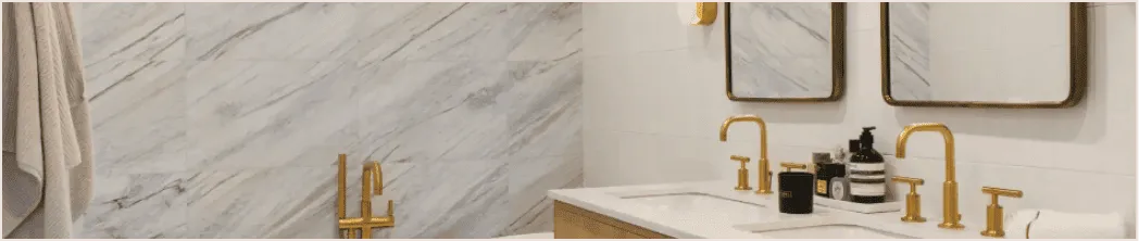 Luxury bathroom renovation with marble walls, gold fixtures, and double vanity — spa-inspired design by Chapter.