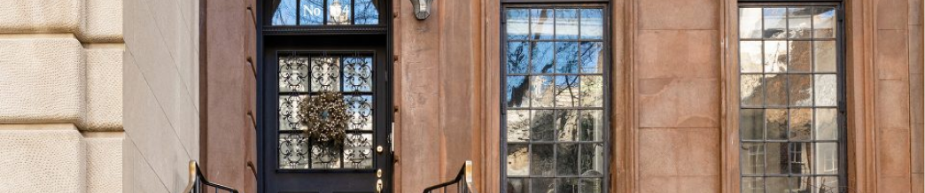 Restored brownstone facade with detailed masonry and black-framed windows — exterior renovation by Chapter.