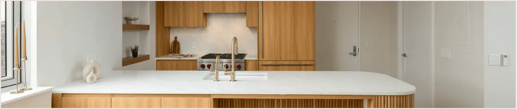 Custom kitchen renovation in New York featuring wood cabinetry, marble island, and built-in appliances — design-build by Chapter.