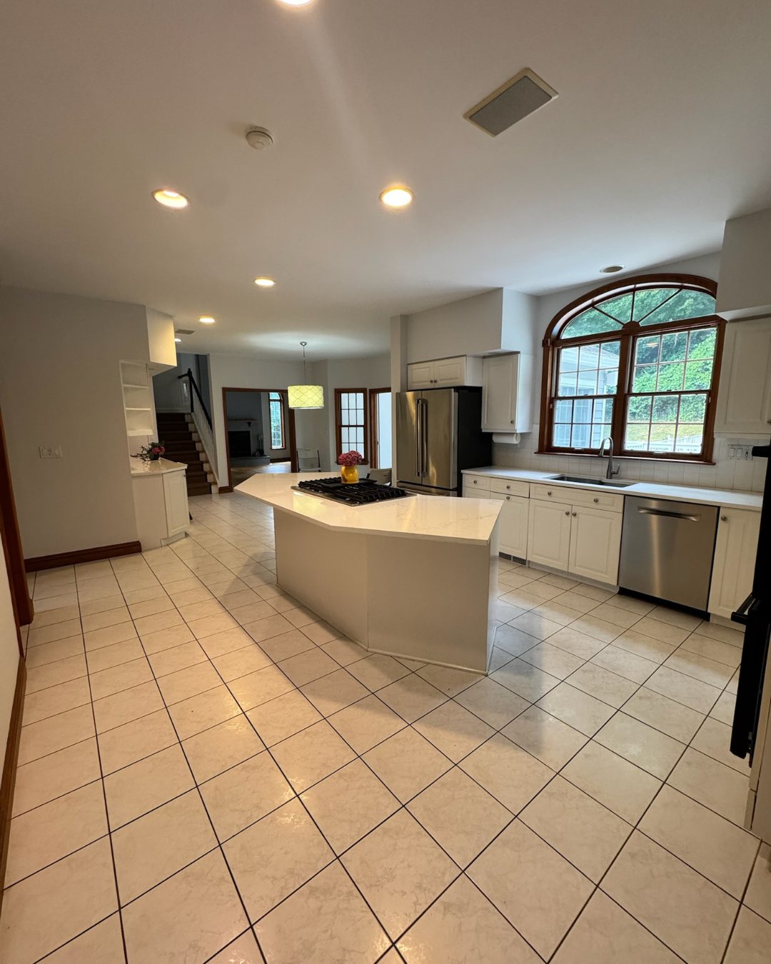 Before view of the original kitchen with tile floors and older cabinets.