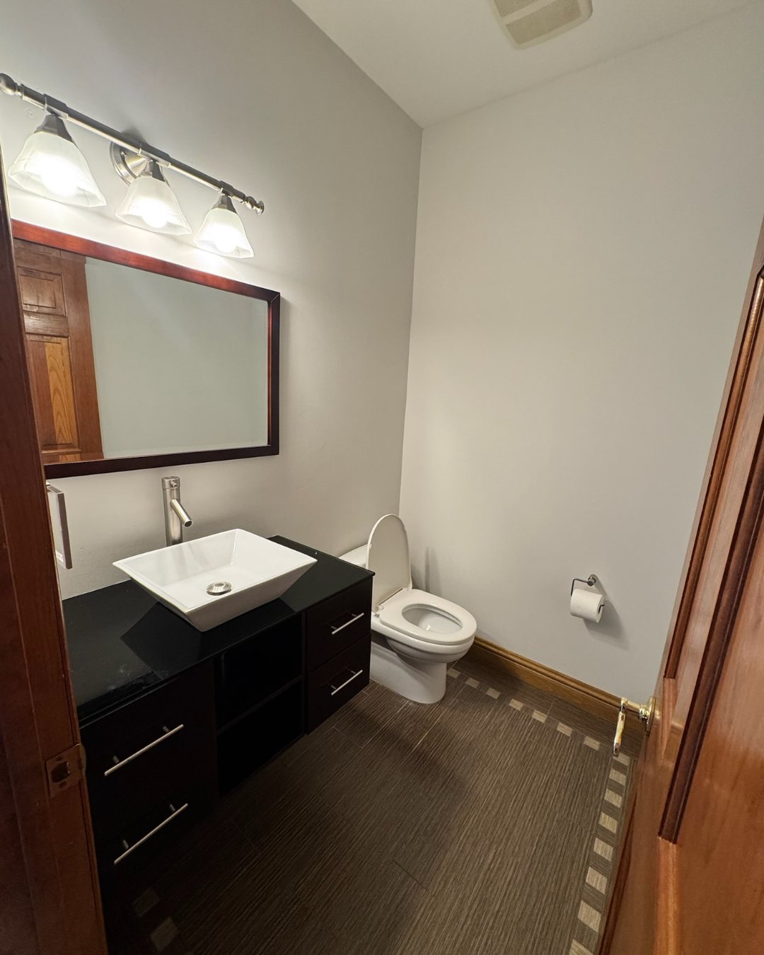 Before view of the compact powder room before conversion to a full bathroom.