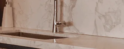 Marble backsplash and countertops with elegant veining in a Miami condo kitchen renovation.