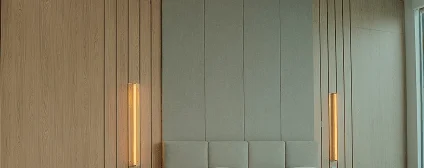 Custom wood paneling and millwork with concealed storage creating refined modern aesthetic in Miami condo