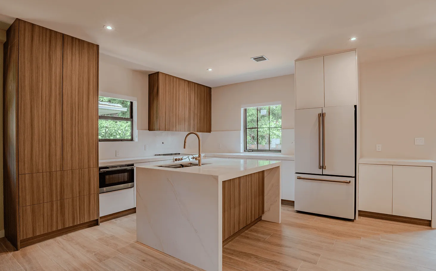 Modernized Coral Gables kitchen with contemporary finishes, custom pass-through window, and improved layout
