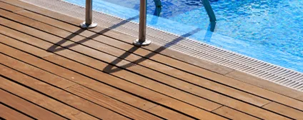 Natural wood decking installed around the outdoor pool area