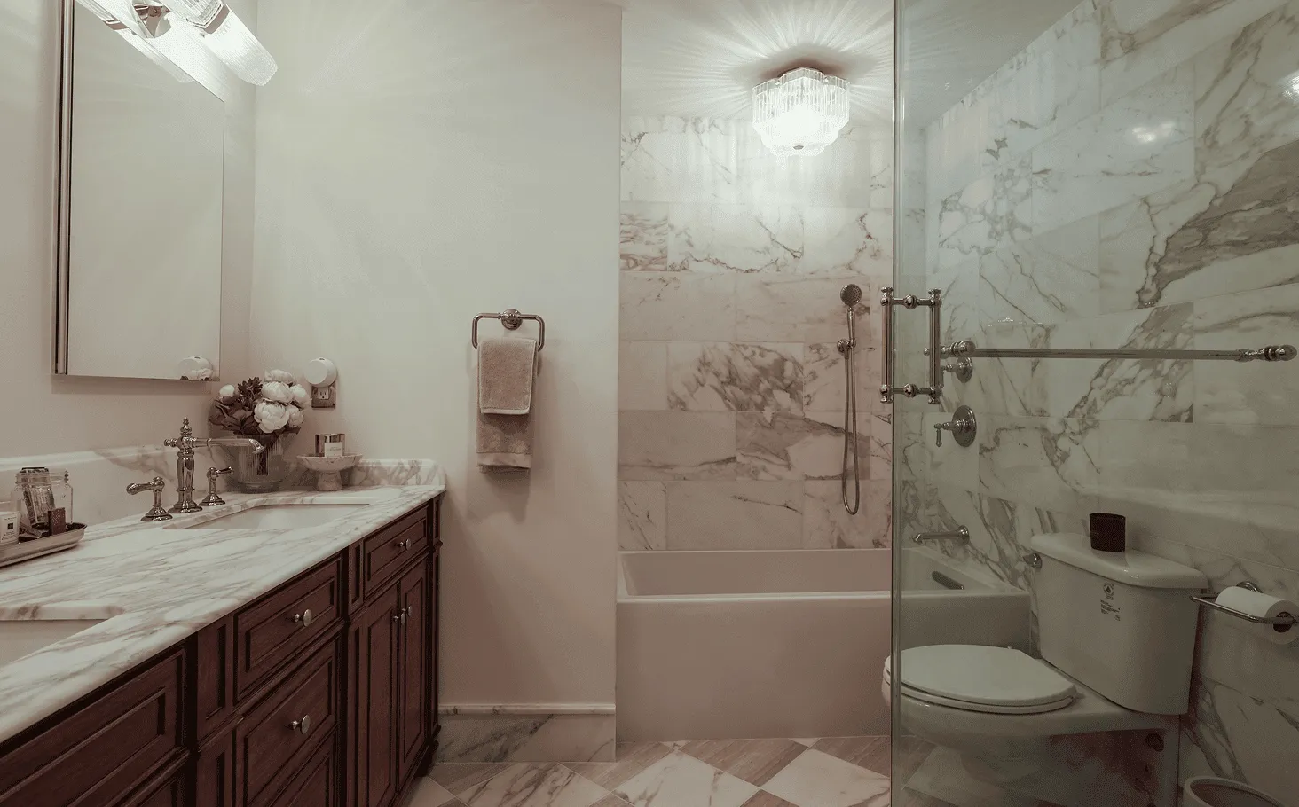 Upgraded bathroom with marble countertops, newly installed tilework, and polished chrome fixtures with 1930s-inspired detailing