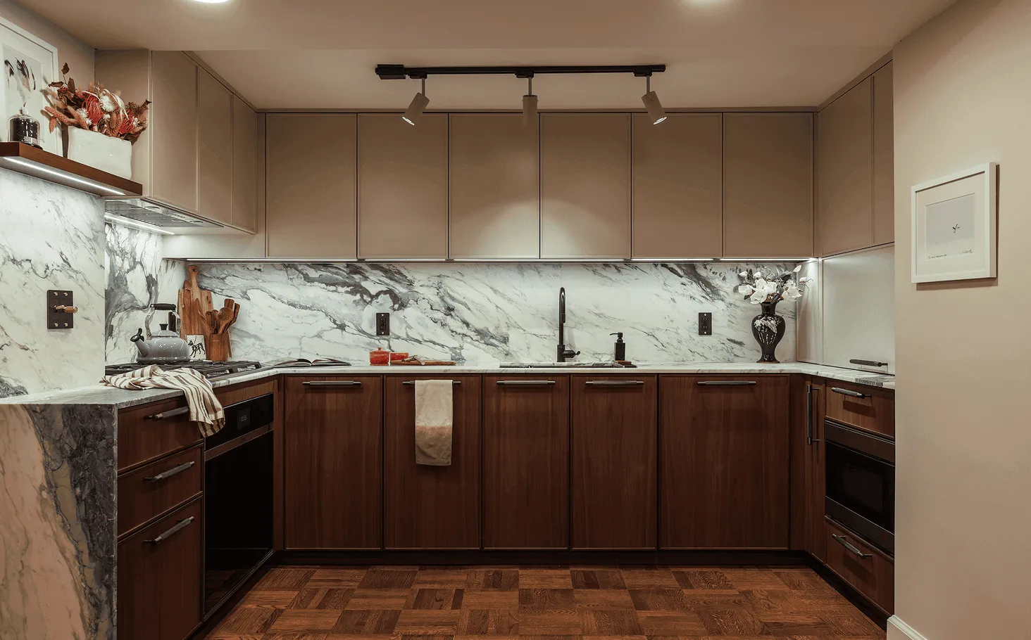 Contemporary kitchen featuring striking Calacatta Turquoise marble backsplash with distinctive veining and panel-ready appliances