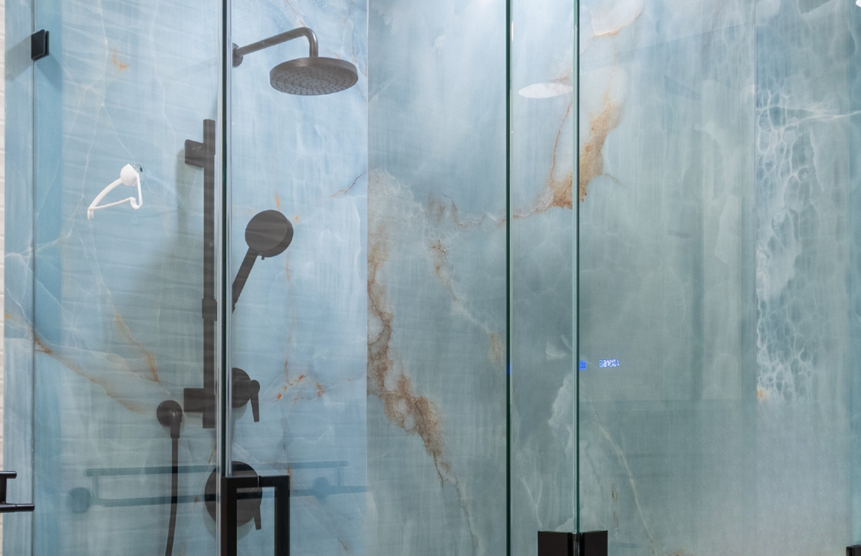 Frameless glass shower enclosure