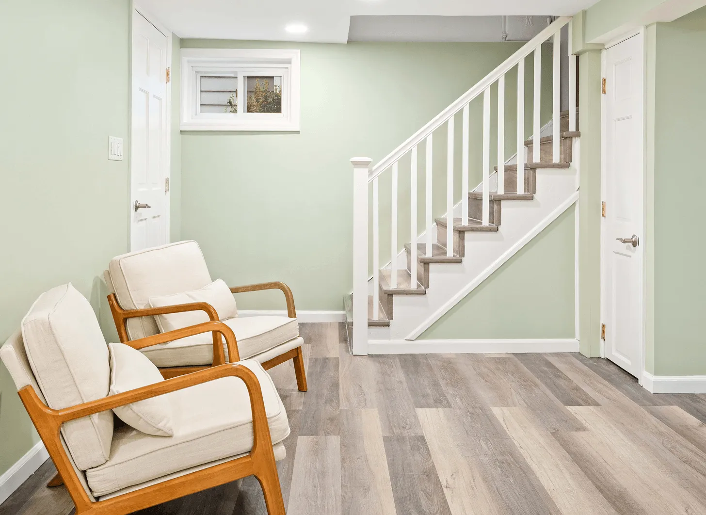 Renovated Maplewood basement staircase with modern railings and updated lighting
