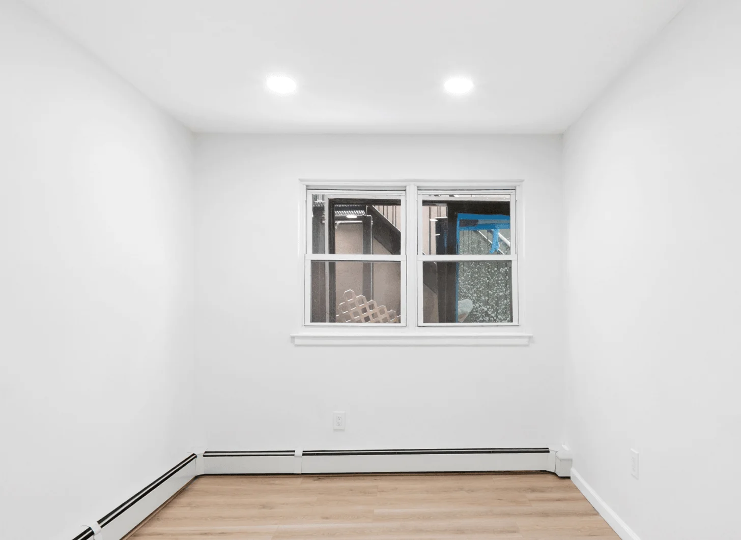 Union City room one after renovation with upgraded cabinetry, lighting, and appliances