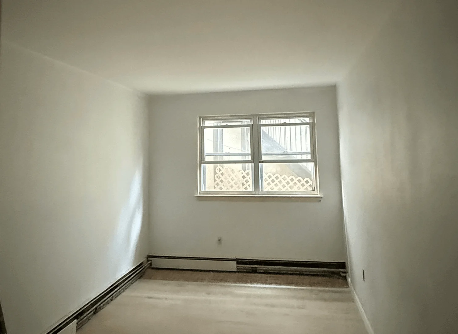Union City room one before renovation with dated cabinets and older finishes