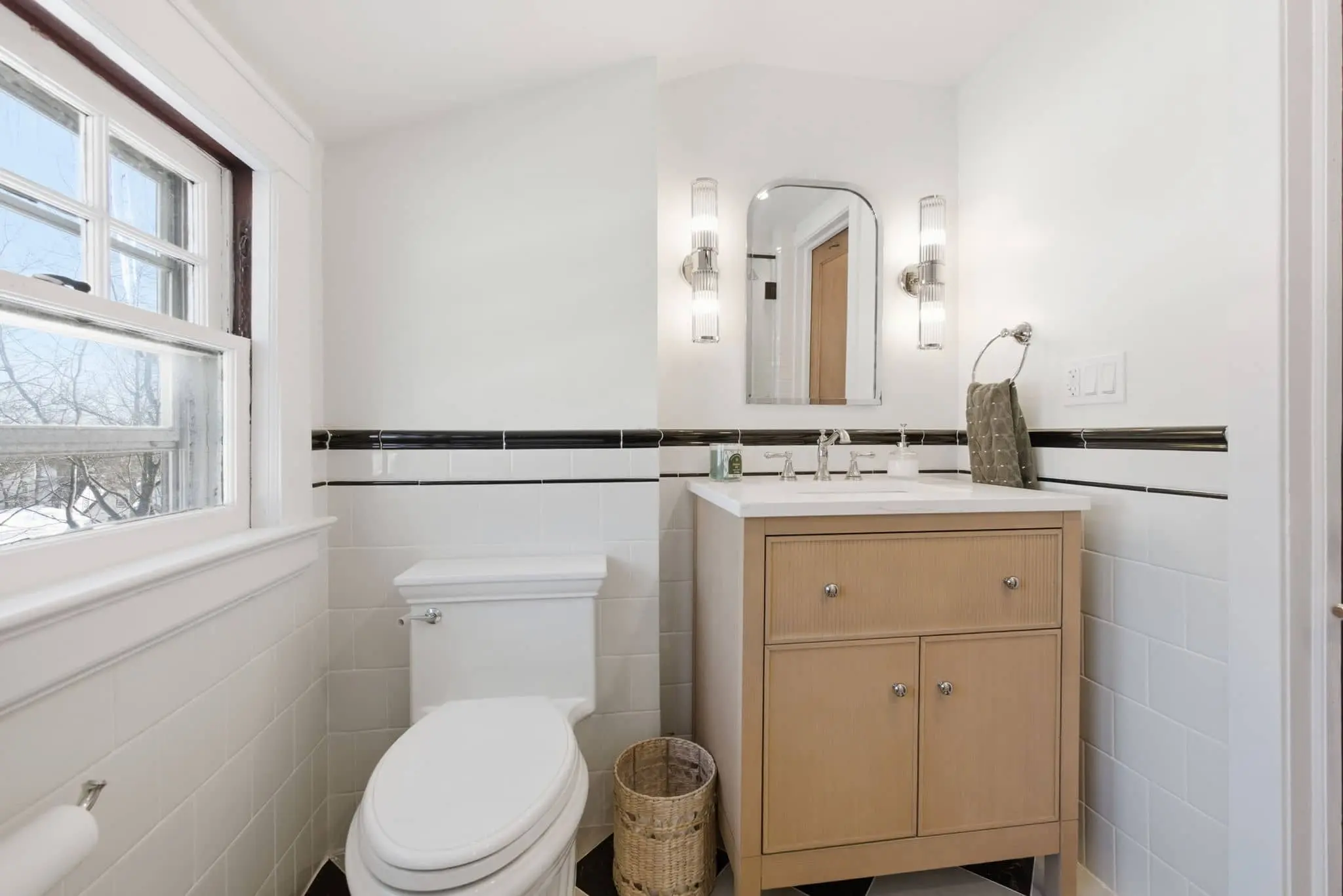 Renovated West Orange third-floor bathroom with checkerboard tile flooring, new vanity, and quartz countertop