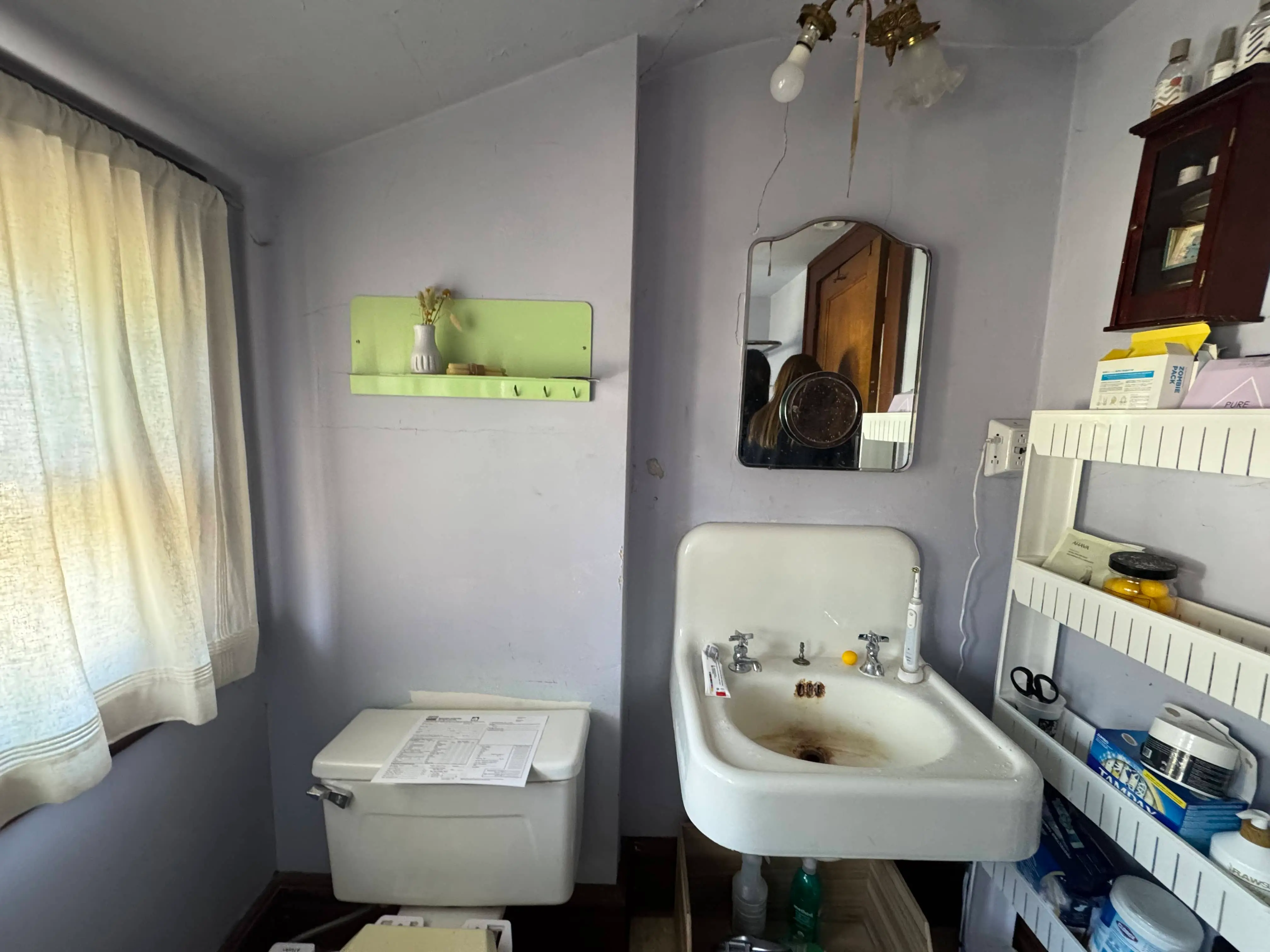 West Orange third-floor bathroom before renovation showing outdated fixtures and worn finishes