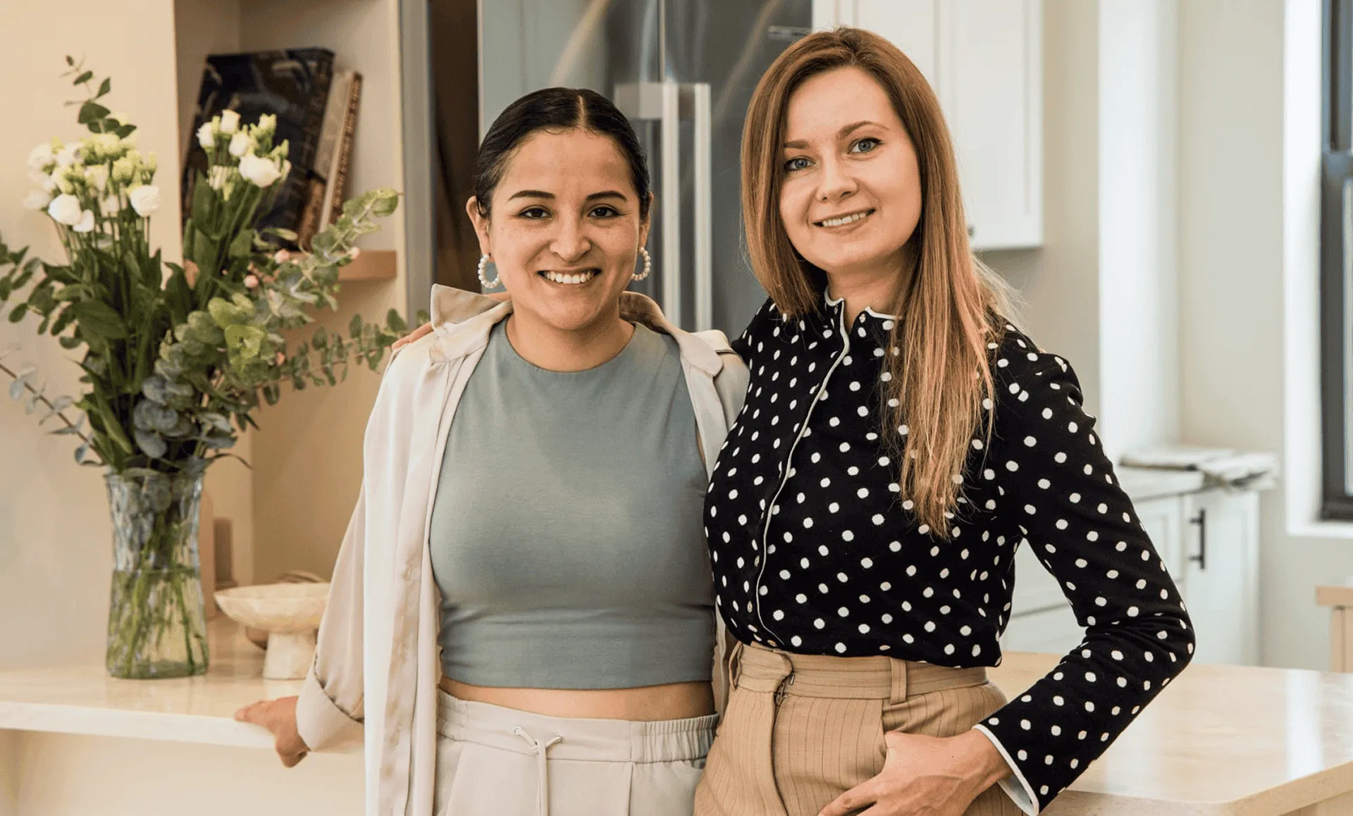 Project manager and interior designer standing together in the renovated kitchen, part of a full apartment renovation at 80 East End Avenue in Yorkville NYC