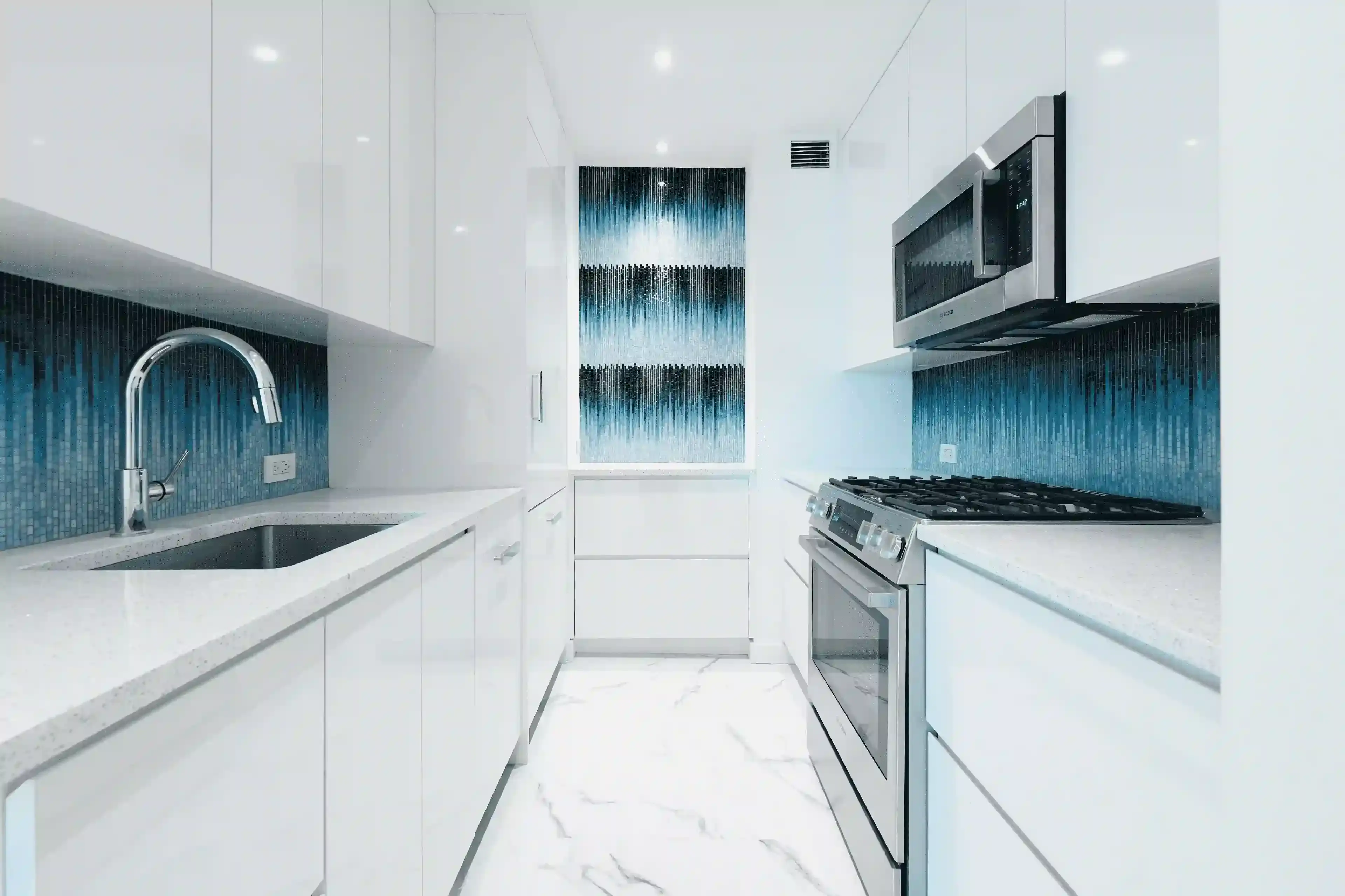 Battery Park City apartment renovation - luxury bathroom with white and blue porcelain tile flooring