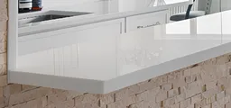 Extended white countertop breakfast bar with stacked stone accent wall