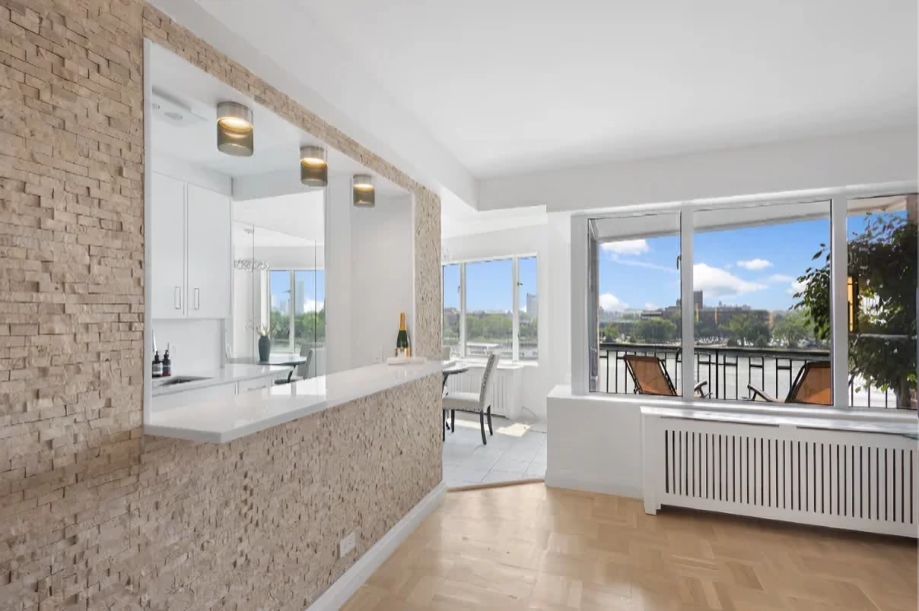 Completed East End Avenue co-op renovation with open living area, kitchen breakfast bar, and East River views