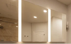 Light-integrated medicine cabinets adding function to the renovated Rye Brook primary bathroom
