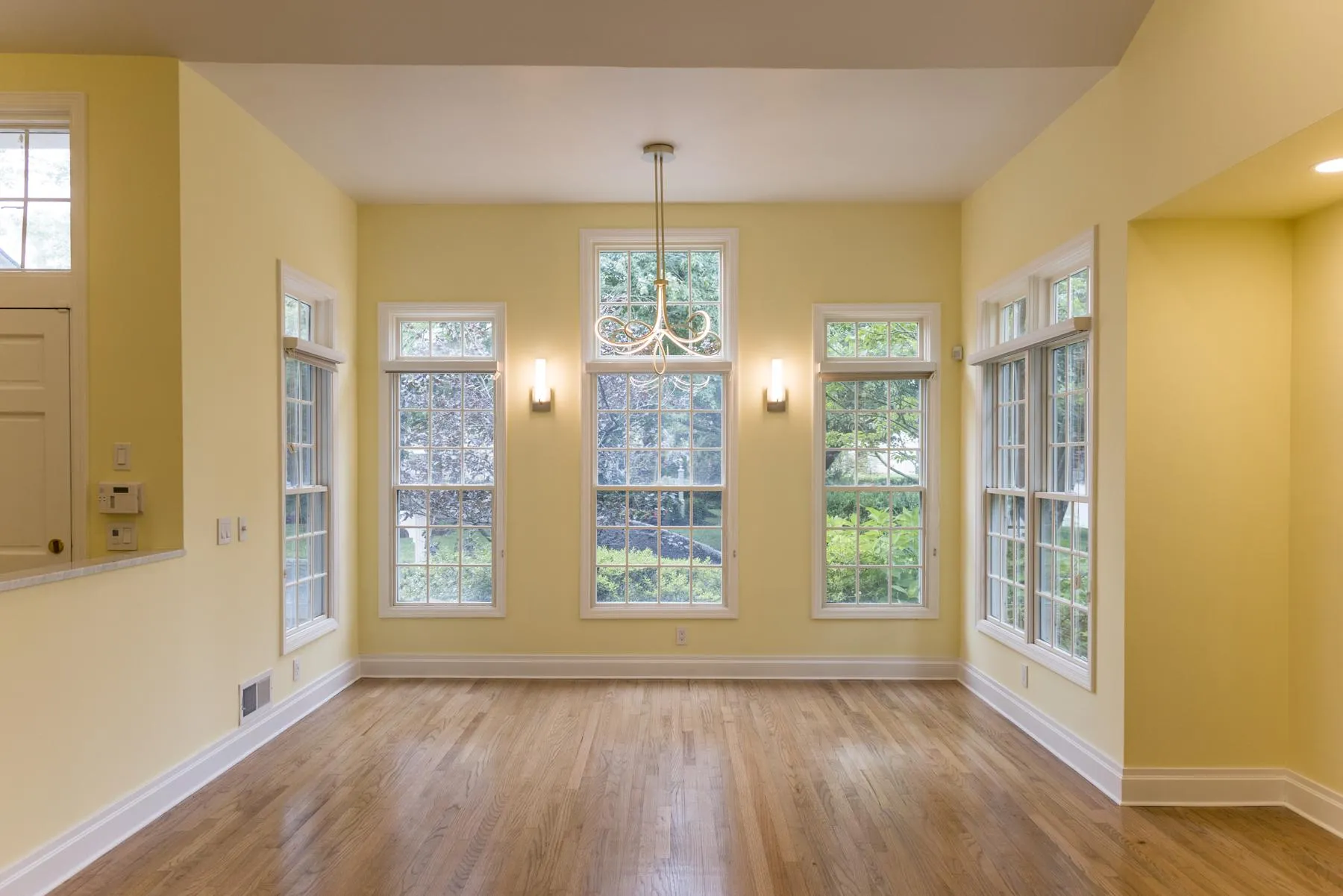 Refinished hardwood floors and updated wall paint throughout Rye Brook home creating a cohesive interior design