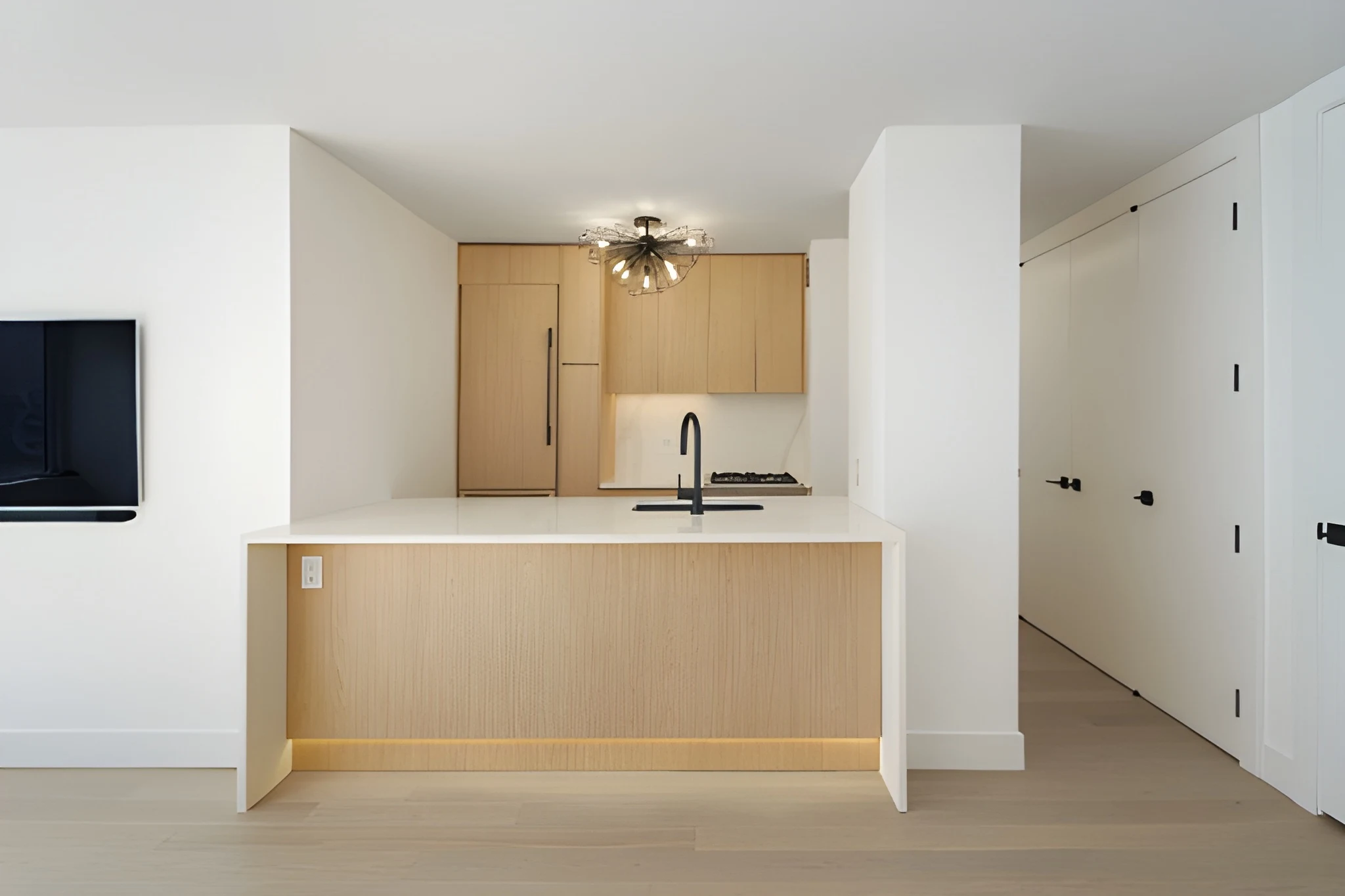 Gramercy co-op kitchen after renovation with white oak cabinetry and modern peninsula