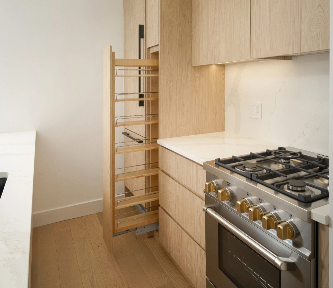 Gramercy co-op kitchen with custom white oak peninsula, under-lighting, and radiant heated floors