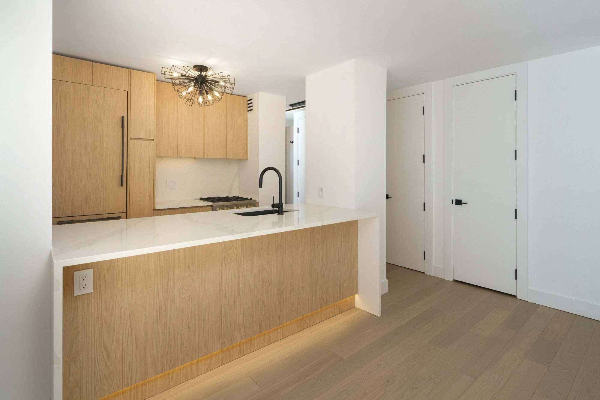 Completed Gramercy luxury co-op renovation with bright modern kitchen and cohesive finishes