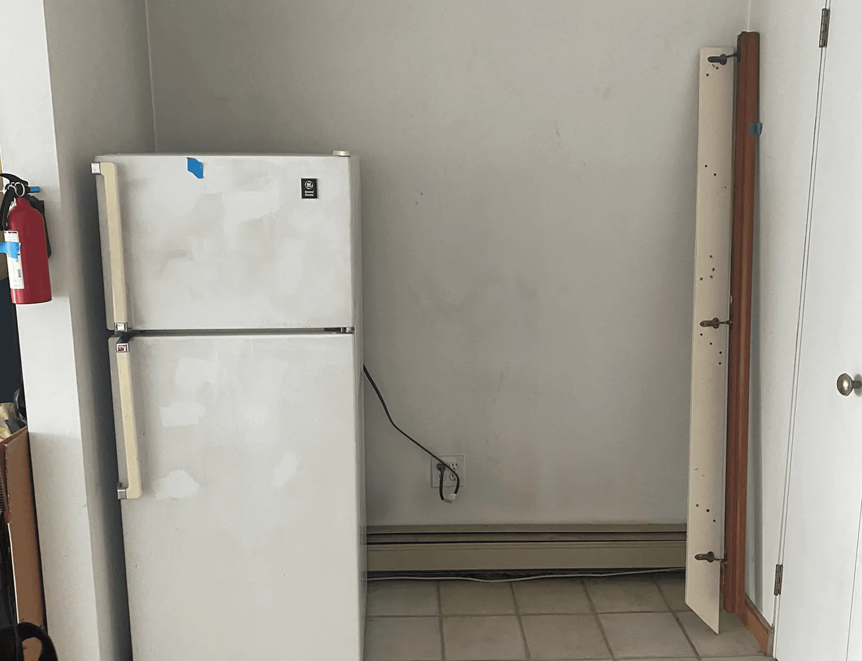 Wall area before renovation showing plain white walls without custom storage