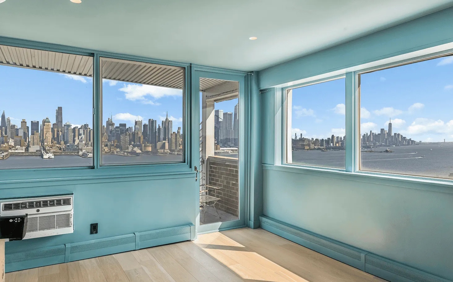 Jersey City apartment interior showcasing custom deep blue walls, white oak floors, and integrated lighting throughout the space