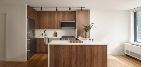 Custom dark wood flat-panel kitchen cabinetry with vertical grain finish