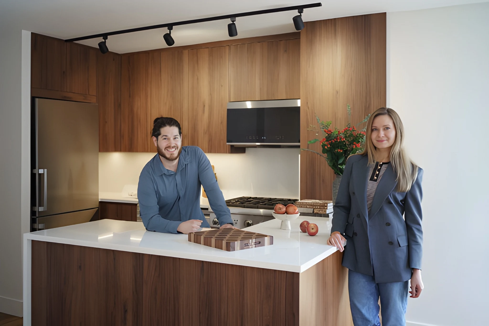 Completed Midtown East condo kitchen renovation with dark wood cabinetry and white waterfall island