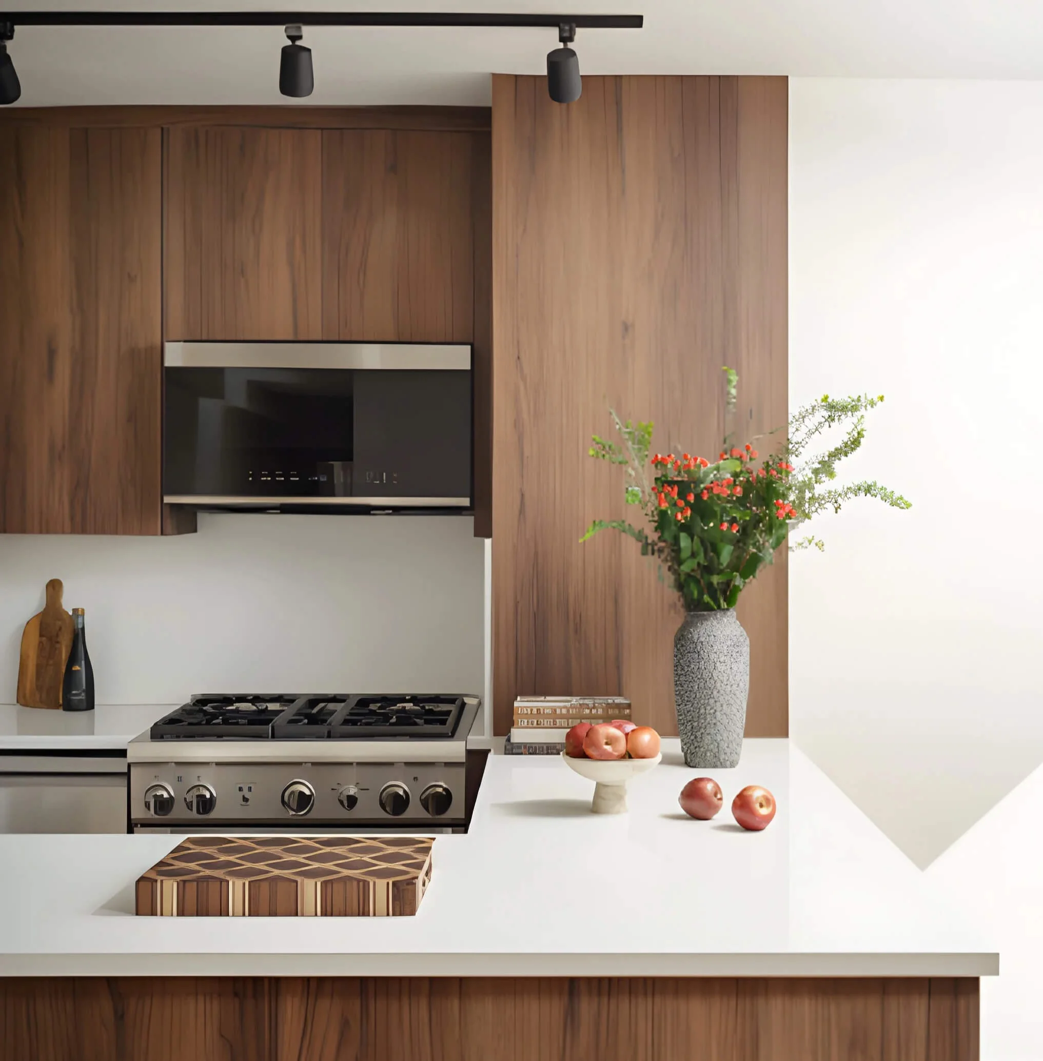 Detail of renovated kitchen with walnut cabinetry, white counters, and stainless steel gas range