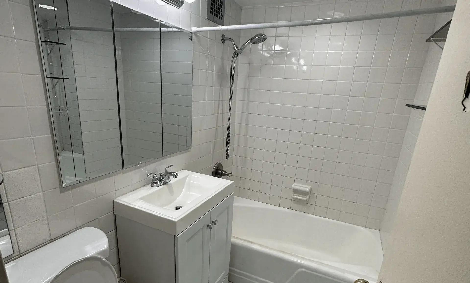 Before renovation view of Manhattan studio apartment bathroom showing outdated fixtures and layout