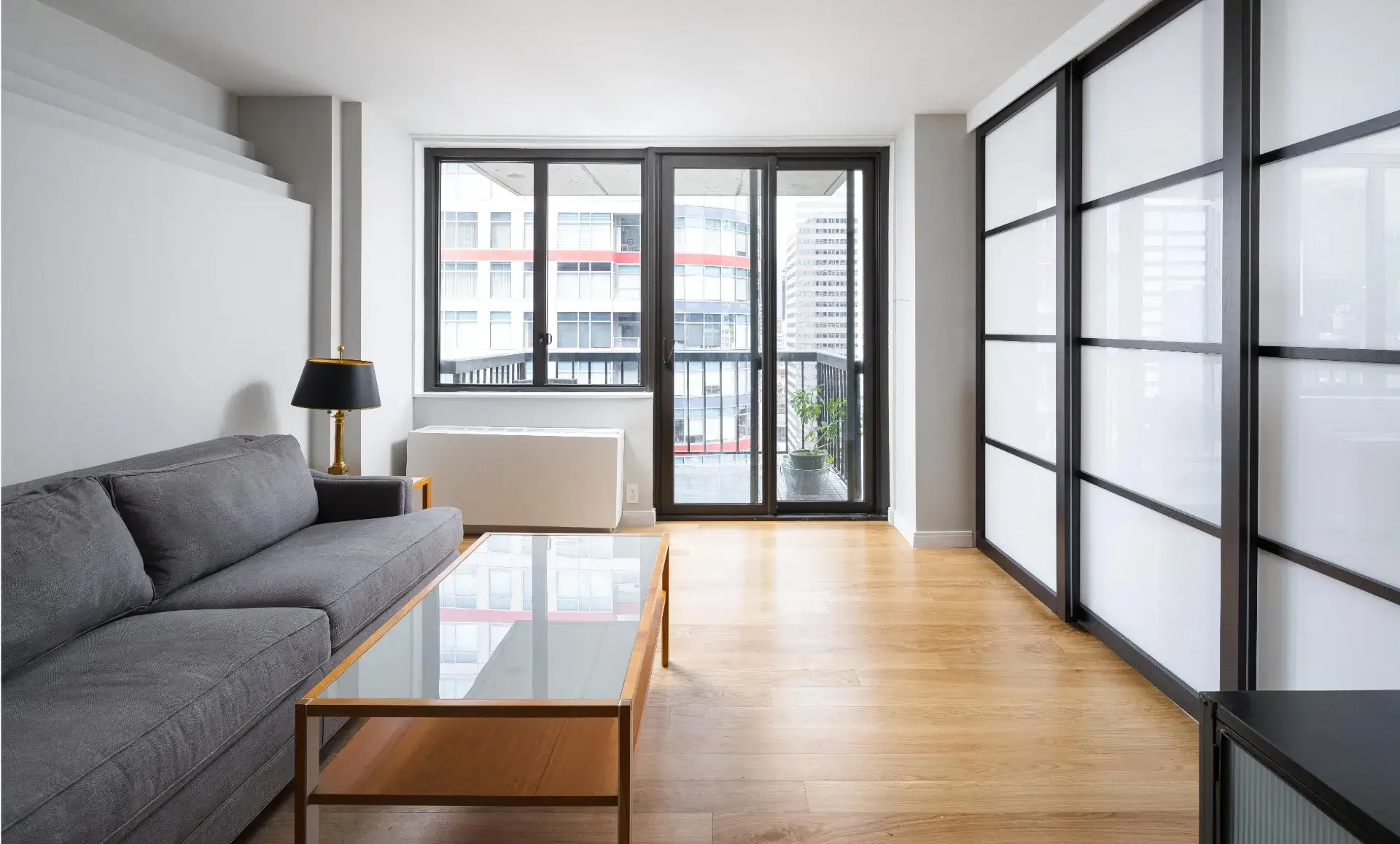 Manhattan condo living space after renovation with sliding doors