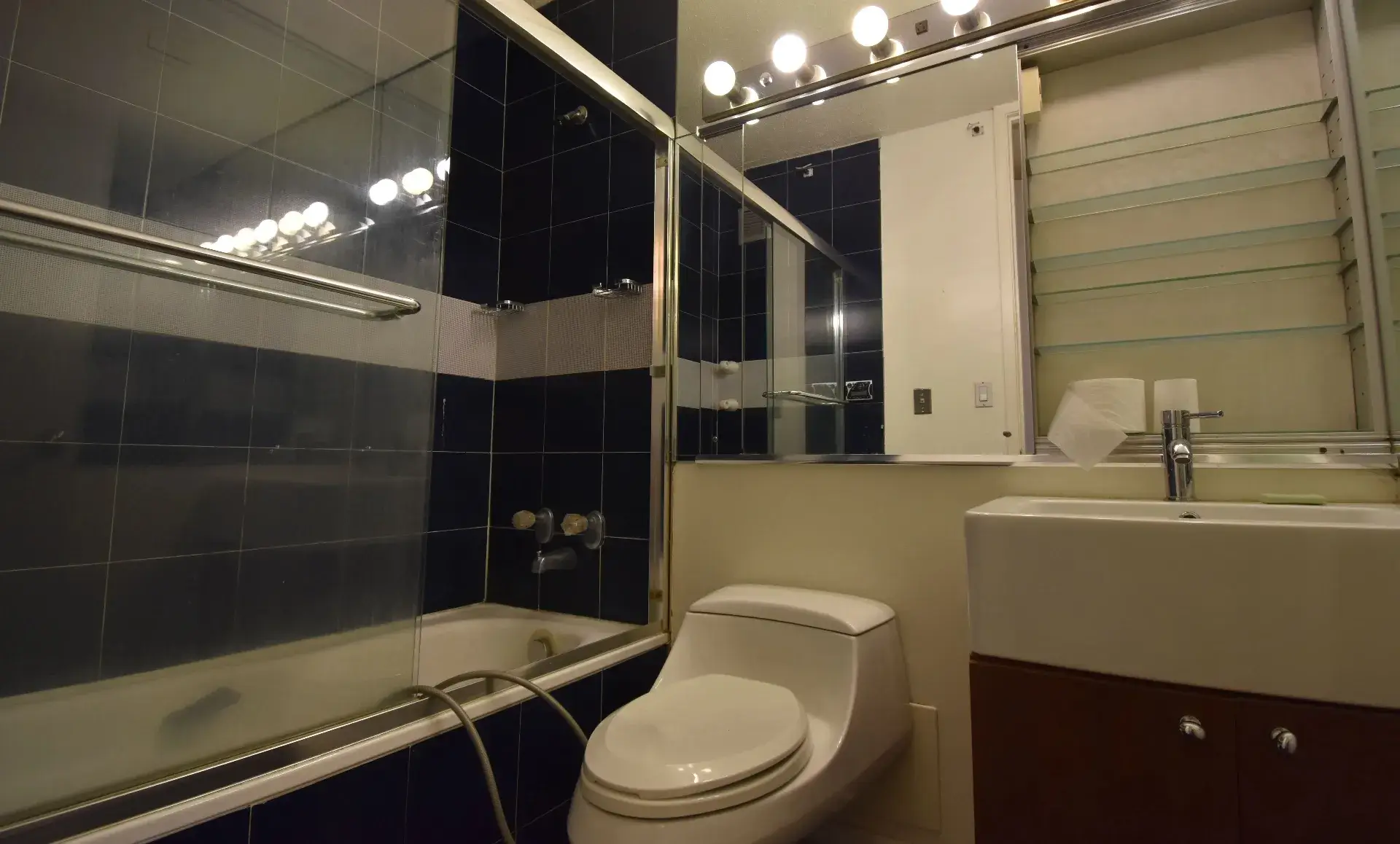 Manhattan condo bathroom before renovation showing old fixtures