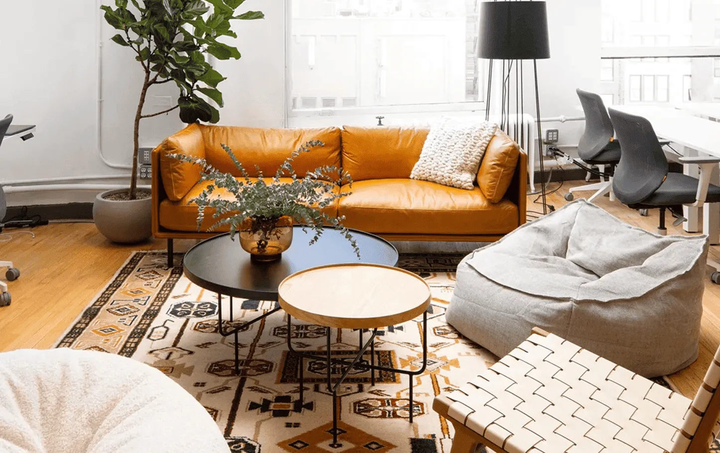 Living and dining area of a renovated Axis Brickell condo featuring custom wood millwork, floor-to-ceiling windows, and modern Scandinavian-inspired furnishings.