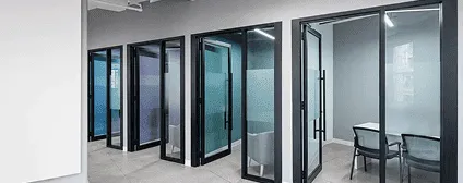 Custom glass partitions and glass-front enclosures for NYC tech office renovation