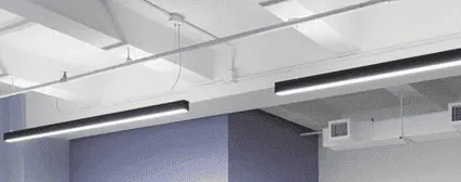 Linear suspended LED lighting fixtures in NYC tech headquarters office