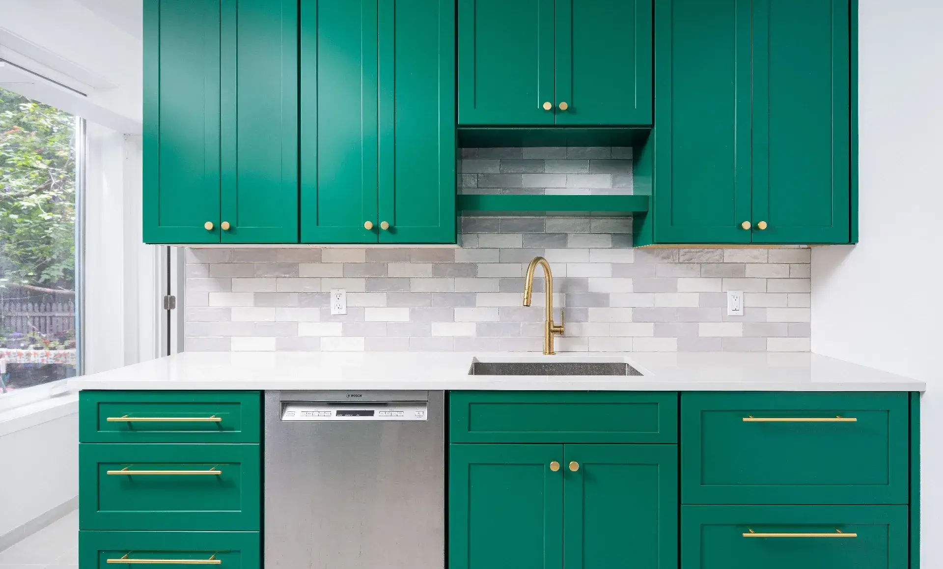 Brooklyn home renovation after photo showing emerald green kitchen with maple interiors