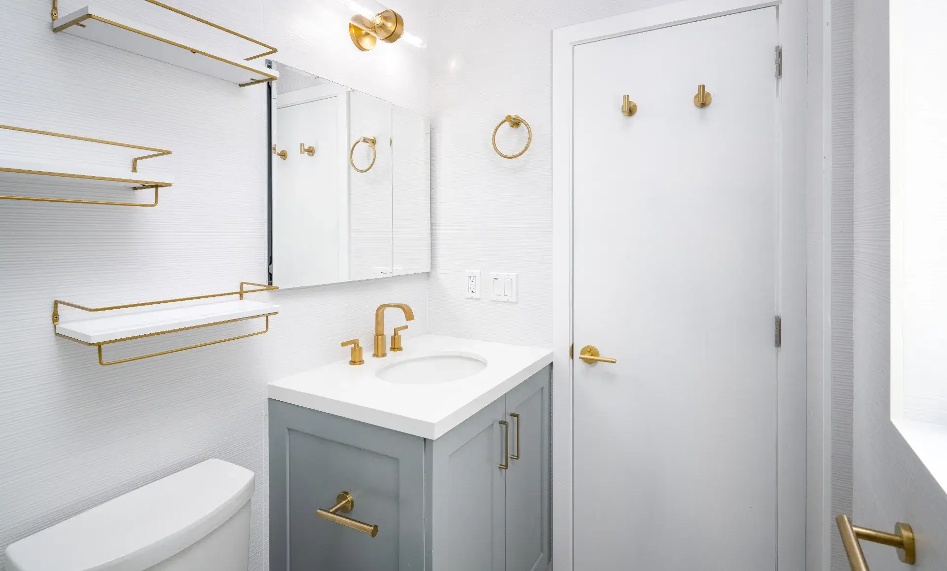 Brooklyn home renovation bathroom with geometric floor tiles and elegant brass fixtures