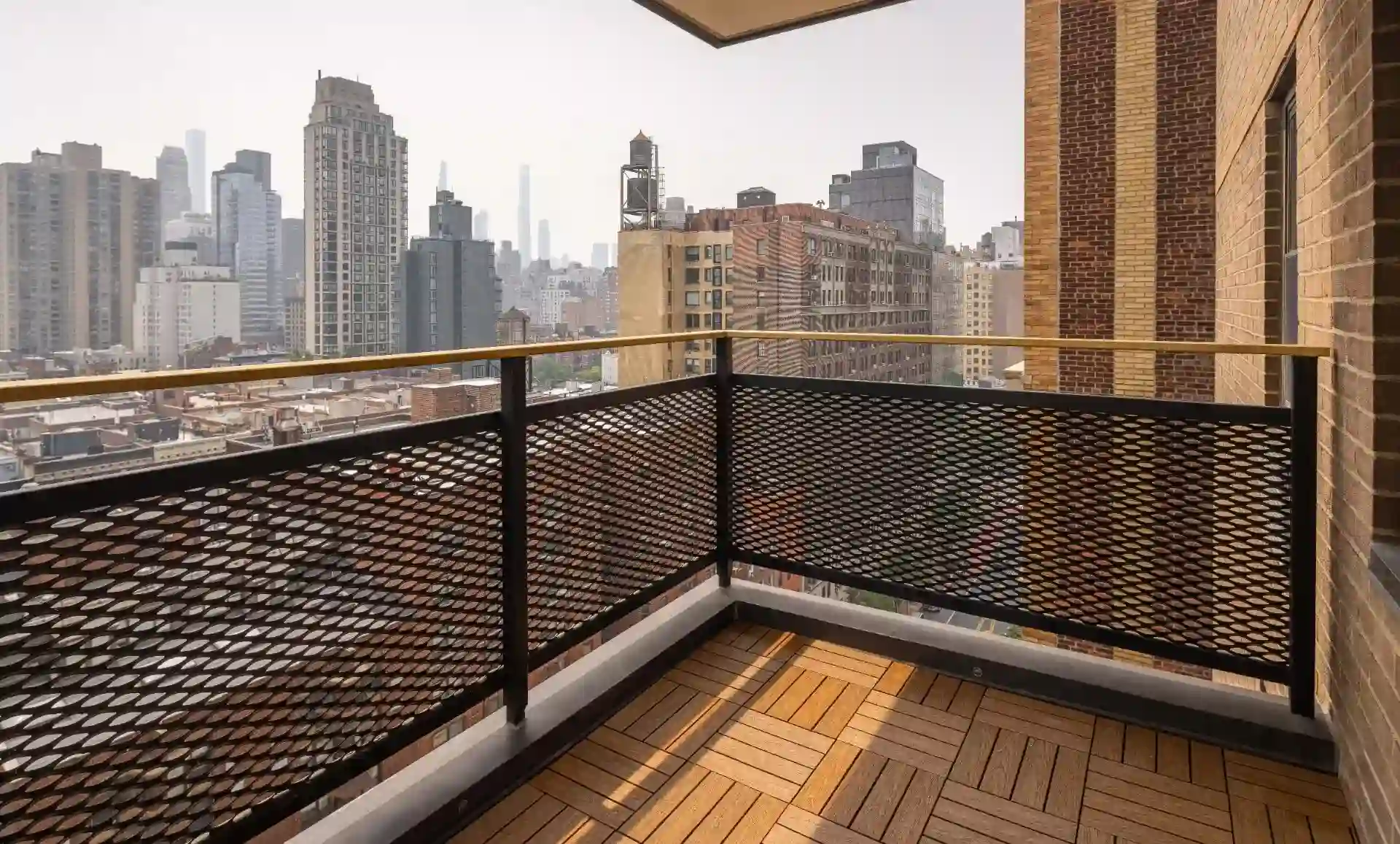 UES apartment balcony with faux-wood deck and city views