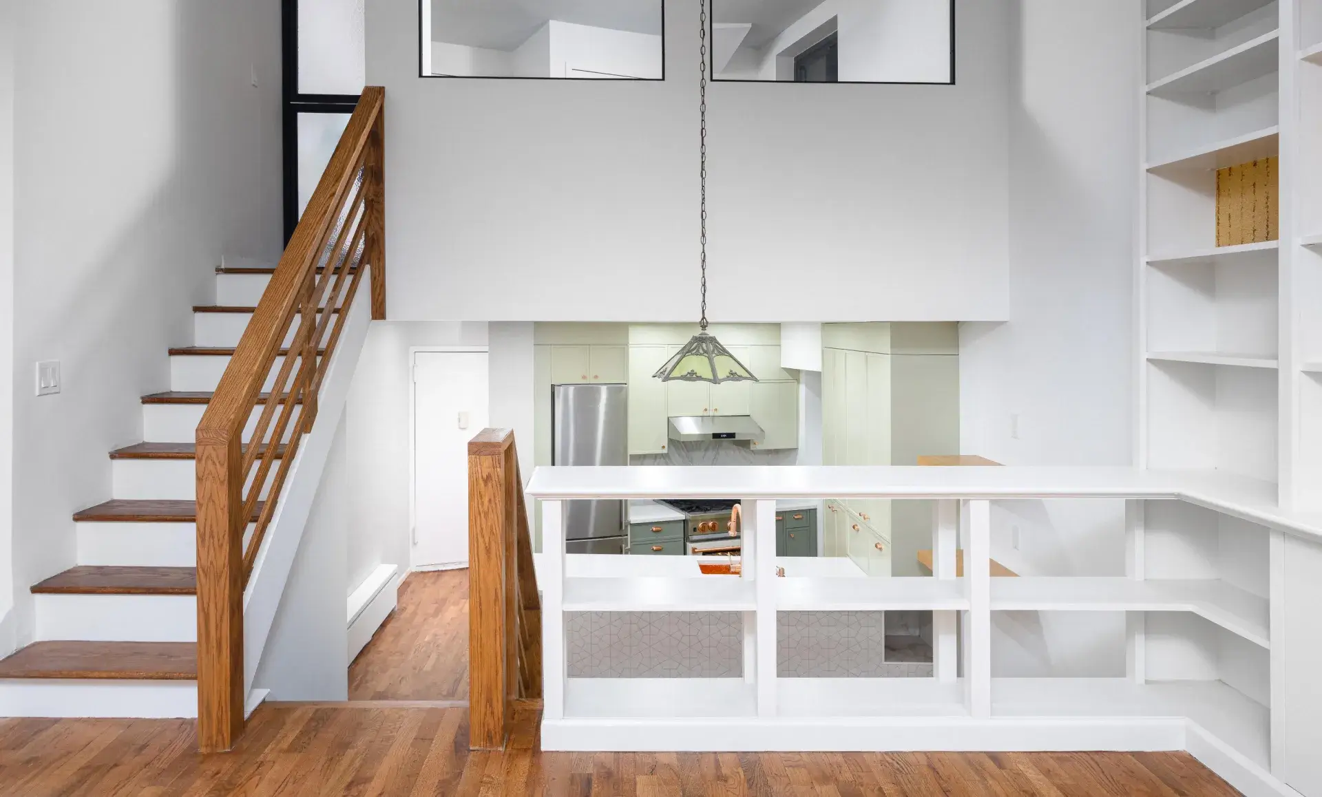 Triplex apartment renovation after photo showing modernized living room with electric fireplace