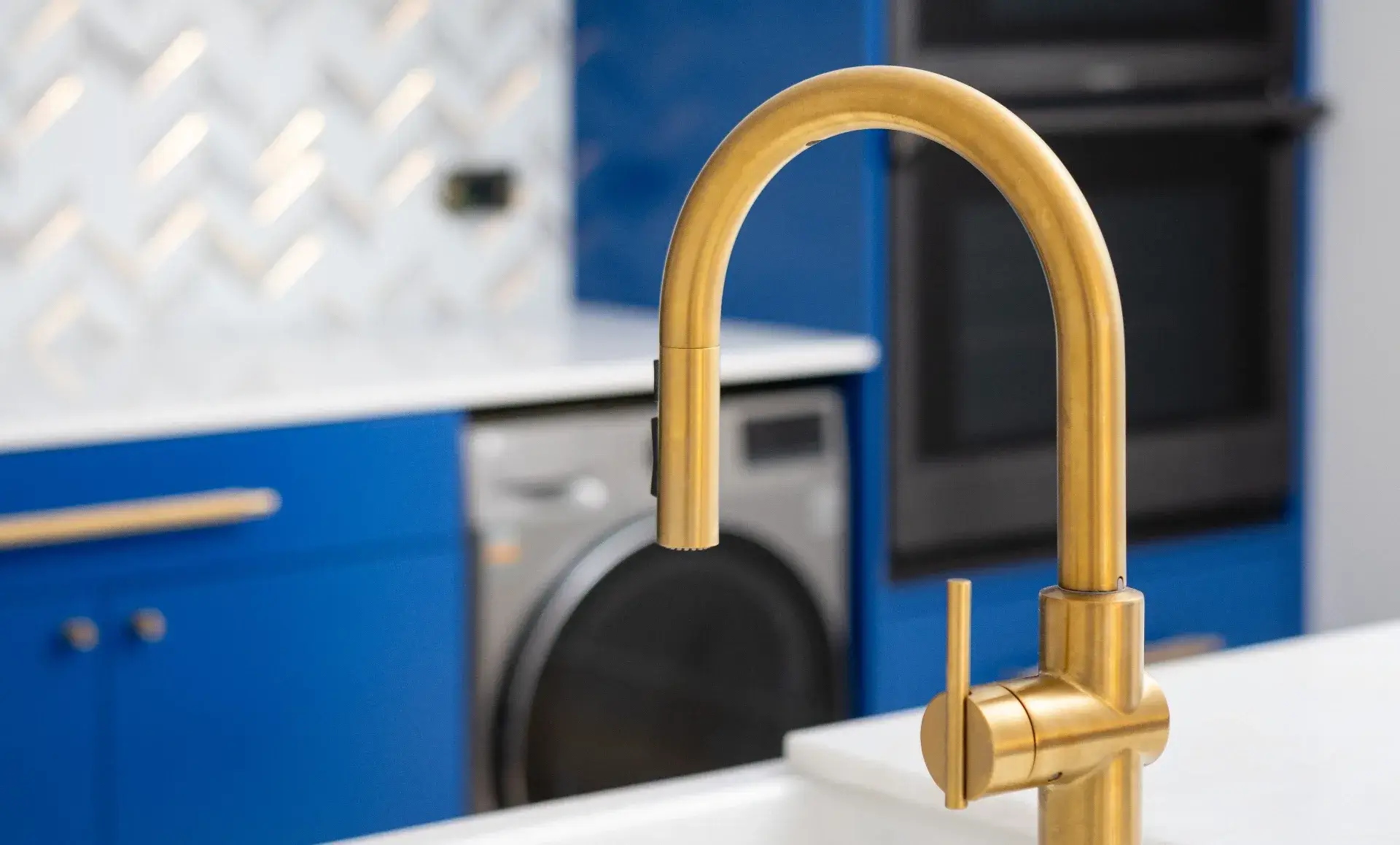 Kitchen renovation details in Williamsburg apartment featuring brass fixtures and smart appliances